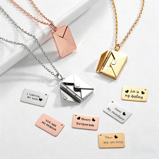Multiple colors of envelope necklaces showing removable metal cards with custom photo engraving and text.
