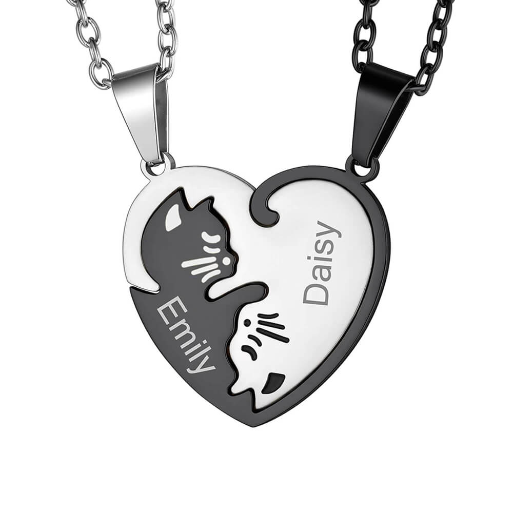 Personalised Matching Cat Heart Necklaces for 2. Features black and silver interlocking pendants with engraved names 'Emily' and 'Daisy'. Durable stainless steel, perfect custom gift for cat lovers.