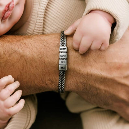 Personalized dad bracelet with engraved family name beads worn by a father with baby