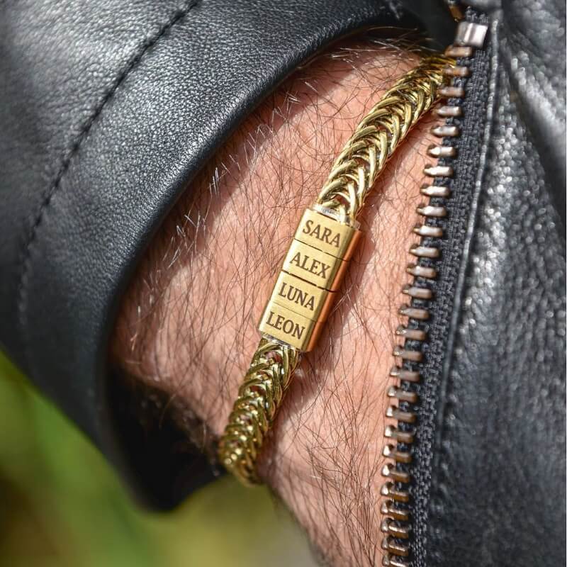 Gold personalized bracelet with engraved family name beads on a man's wrist