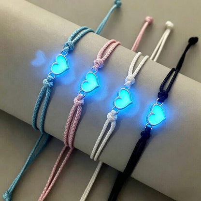 Close-up of 4 matching bracelets with glowing blue heart charms, a perfect gift for a group of 4.