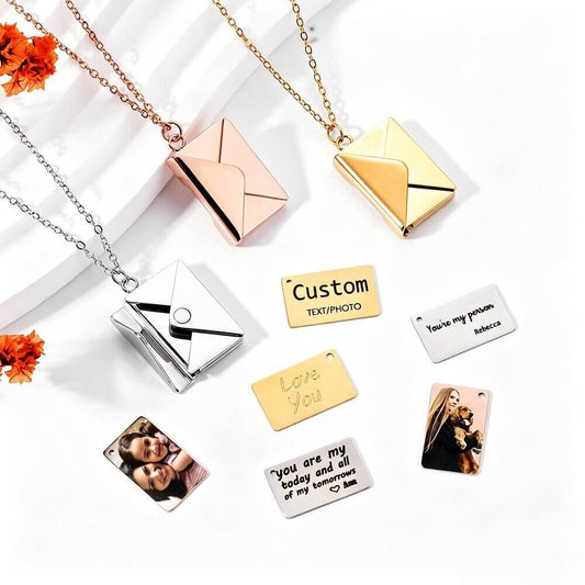 Close-up of envelope necklace with a fully engraved metal insert featuring a custom photo on the reverse and personalized text
