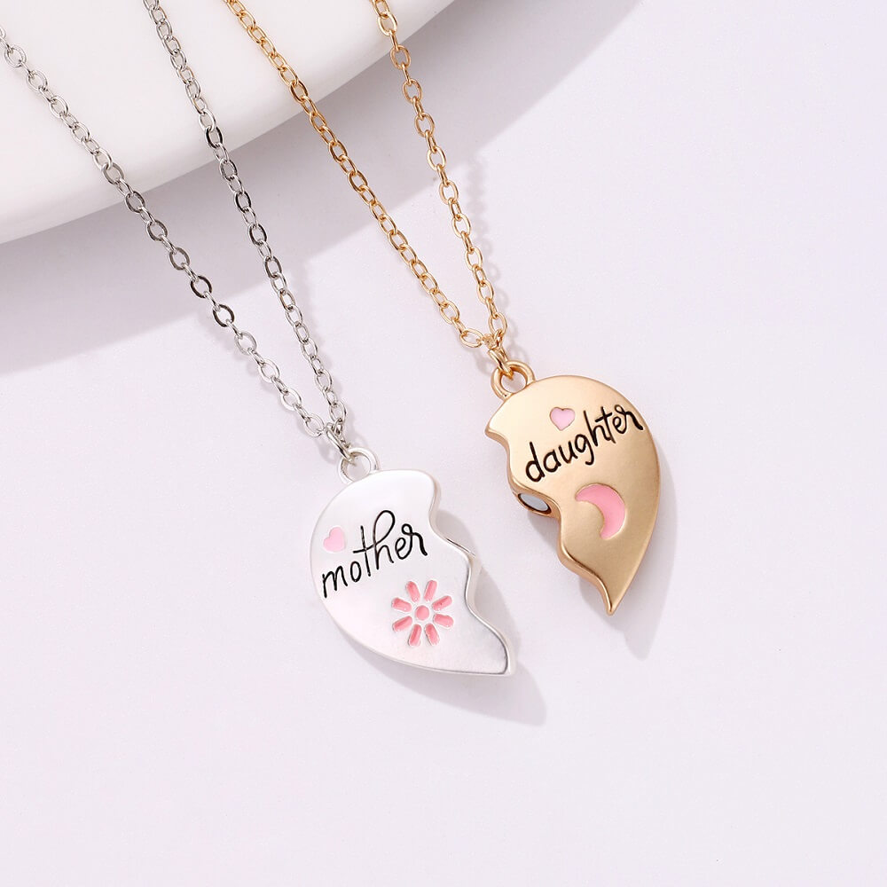 Close-up of interlocking heart-in-moon puzzle pendant for mother and daughter